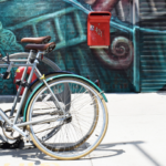 Insights Blog Post Header - Bicycle in front of teal mural