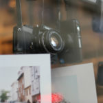 Photography prints and cameras on display in shop window