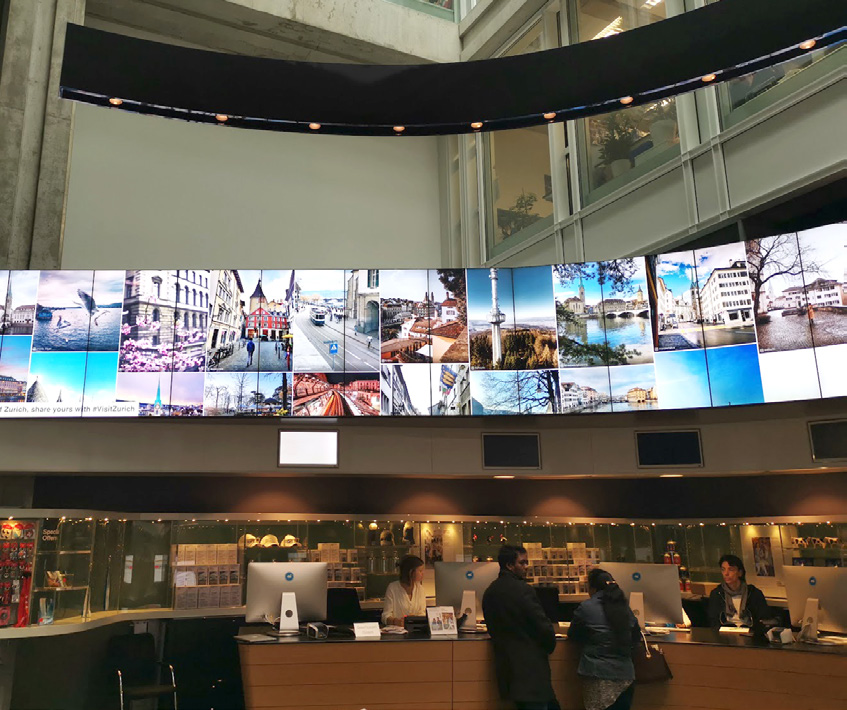 An example of a large digital display screen in Visit Zurich’s main tourist info center, which is located in their largest railway station.